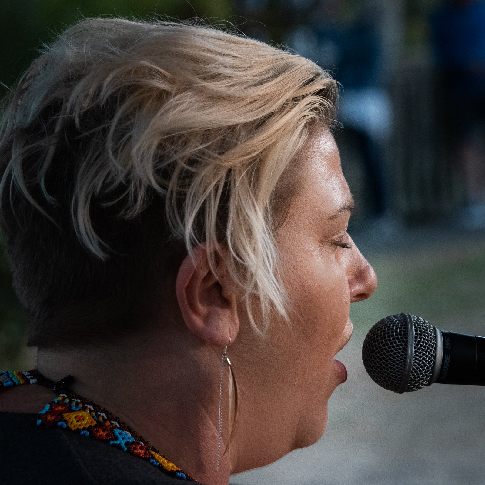 Suzanne Gay singing, close up at microphone